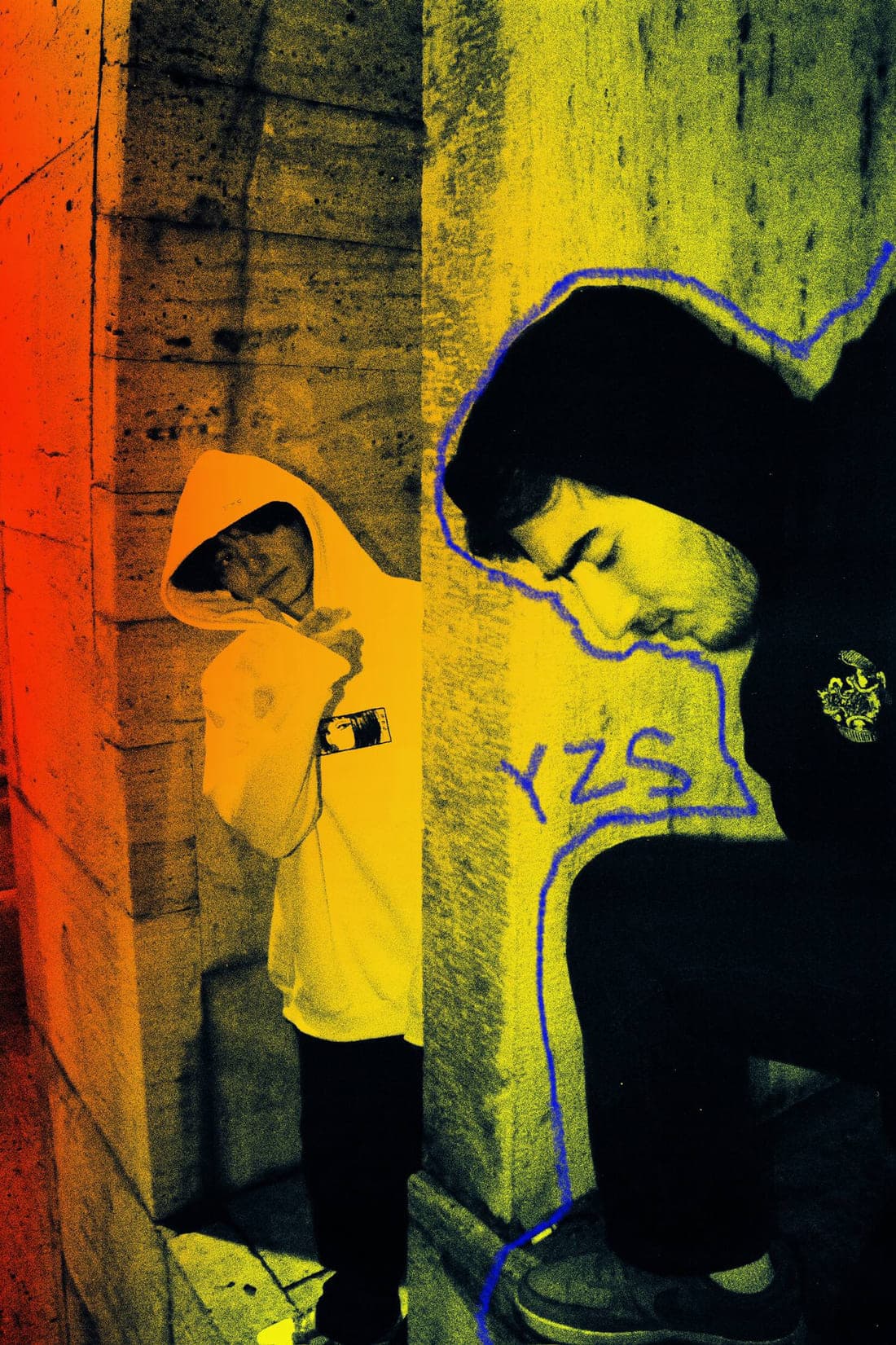Two figures against concrete, YZS drawn beside them in blue marker